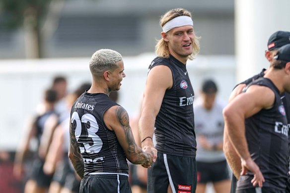 Darcy Moore and Bobby Hill last mon th. The skipper says the Magpies can still launch a premiership tilt, but they will need the forward to return.