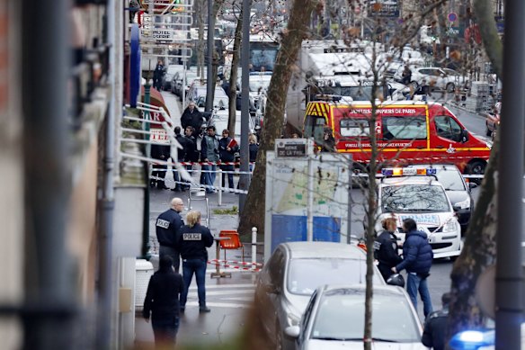 Police, paramedics and firefighters at the scene of the shooting in the south Paris on Thursday, January 8. 