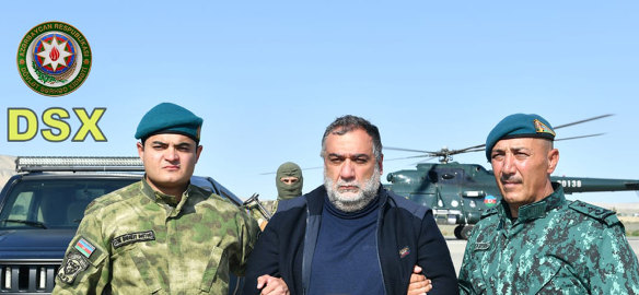 Azerbaijan’s border guard officers hold Ruben Vardanyan, centre. The former head of Nagorno-Karabakh’s separatist government was detained after he tried to cross into Armenia on Wednesday.