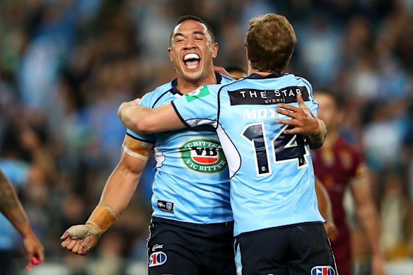 Tyson Frizell of the Blues celebrates scoring a try.