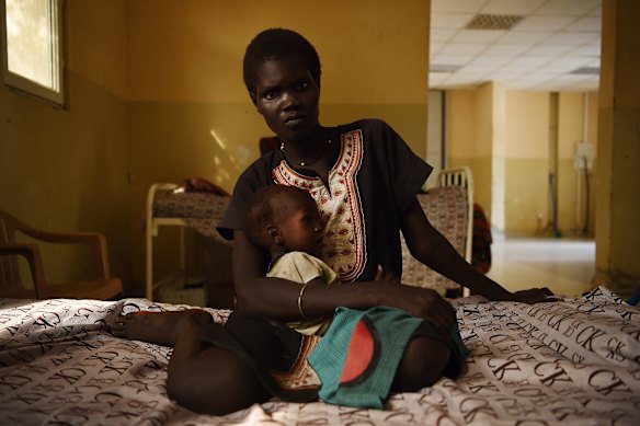 Nyereka Maliyah, 20, with her baby Dictor Geng, 1, who is ill and being treated at the CARE Stabalization point at Bentiu hospital, Bentiu, Unity State, South Sudan. 