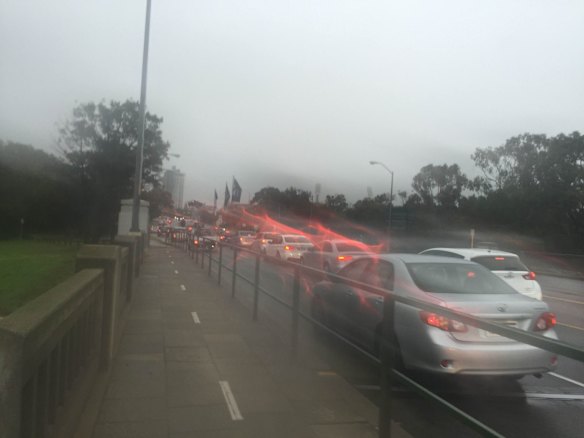 Traffic banked up on the Causeway after heavy rain cause deep puddles.