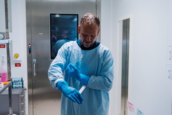 Associate Professor Stuart Turville dresses in PPE gear. 