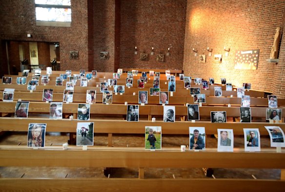 Photos of believers who were asked to send in pictures are attached to the rows of seats, for an Internet broadcast service in the empty St. Barbara church in Obrhausen, Germany.