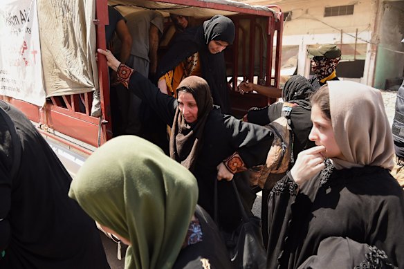 Families arrive at a screening point in West Mosul.