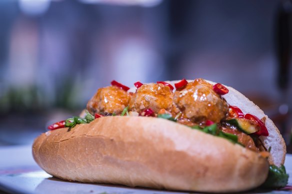 Nhu Lan's xiu mai baguette is spread with chicken pate and "egg butter", then stuffed with pork meatballs, fried onion, coriander, chilli, pickled carrot and radish, fresh cucumber and a squirt of soy sauce.