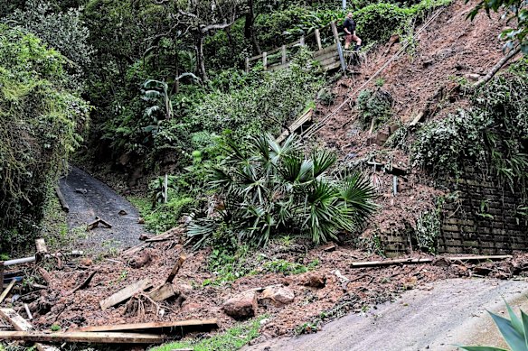 A resident looks over the landslide on Nareen Ave in the northern beaches Sydney suburb of Narrabeen which took out access to a number of houses.