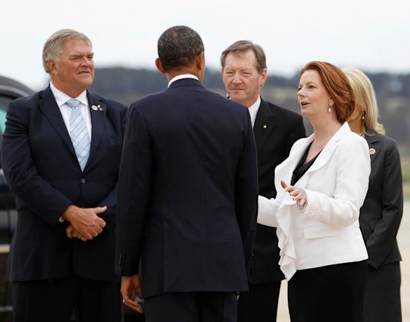 Australia's Prime Minister Julia Gillard welcomes U.S. President Barack Obama upon his arrival in Canberra, Australia. At left is Australia's Ambassador to the United States Kim Beazley.