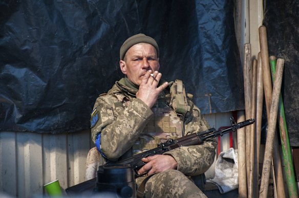 A Ukrainian serviceman takes a moment for a cigarette in Kharkiv.