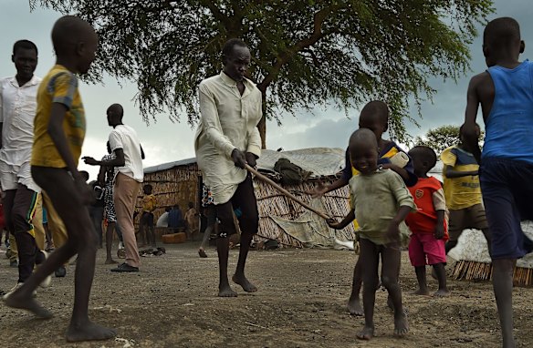 James Tut, 64, who became blind in 2005 is led by a child inside the UN Bentiu Protection of Civilians (POC) site. James Tut was forced to flee the fighting in Leer and two of his daughters were taken by force and he doesn't know where they are. Bentiu, Unity State, South Sudan.