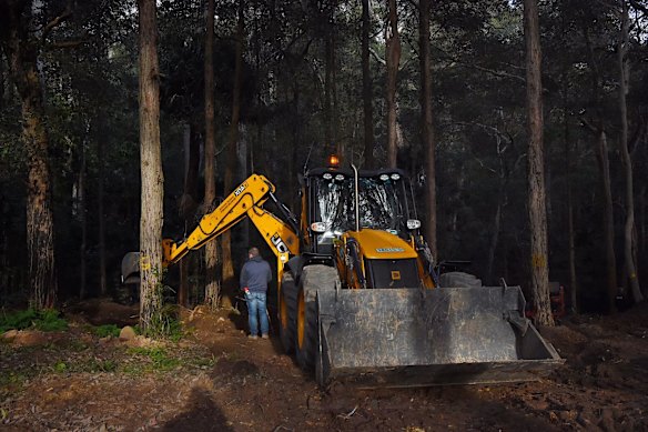 A NSW Detective watches the digging at the site where the search continues for the burial place of their son Matthew Leveson in the Royal National Park.