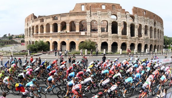 The pack of cyclists pedals past the ancient Colosseum during the last stage of the Giro d'Italia.