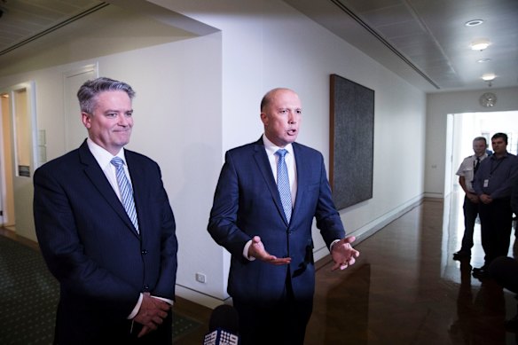 Senator Mathias Cormann and Former Home Affairs Minister Peter Dutton leave after a party room and leadership spill resulting in Treasurer Scott Morrison being elected leader of the liberal party and Josh Frydenberg being elected deputy leader at Parliament House in Canberra.