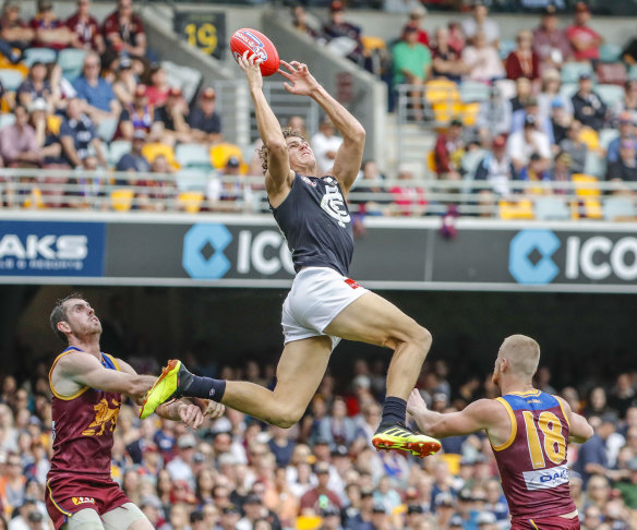 Grab and go: Charlie Curnow flies for an attempted mark during round 16 loss to Brisbane at the Gabba.