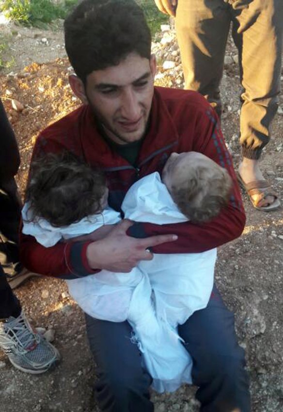 Abdulhamid al-Youssef holds his twin babies who were killed during a suspected chemical weapons attack in Khan Sheikhoun town, in the province of Idlib, Syria