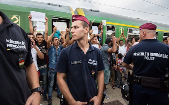 Migrants protest against being taken to a refugee camp from a train that was held at Bicske station in Hungary.