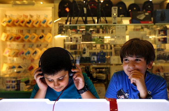 Yasser Wathiq 11 (left) from Baghdad and Ali Ihsan 11 from England (right) listen to music in a store in the Mansour Mall in Mansour a predominantly sunni area of Baghdad.