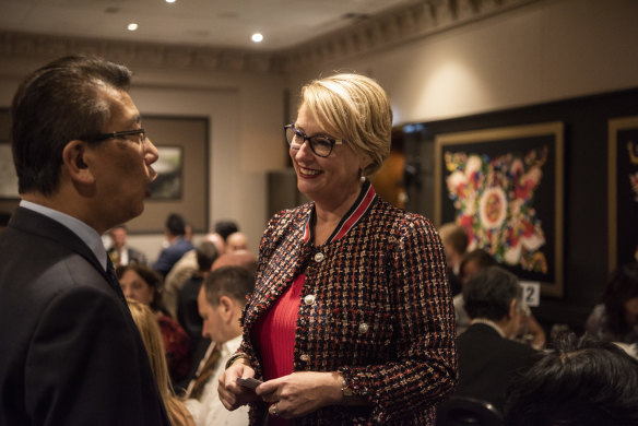 Sally Capp talks to another candidate for lord mayor, Ken Ong, at Thursday night's candidates forum.