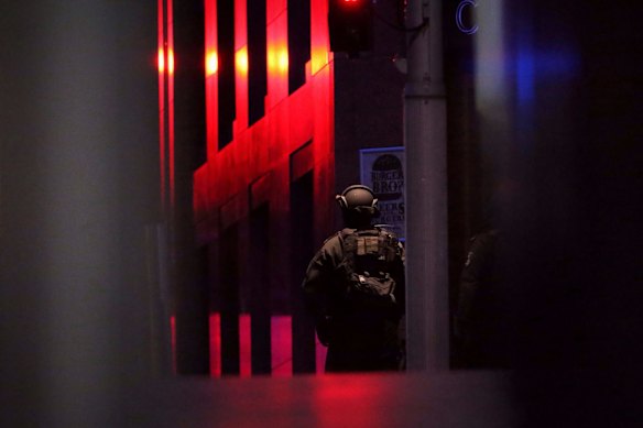 NSW Tactical Operations Unit police officers keep watch outside the Lindt Chocolat Cafe before the siege.