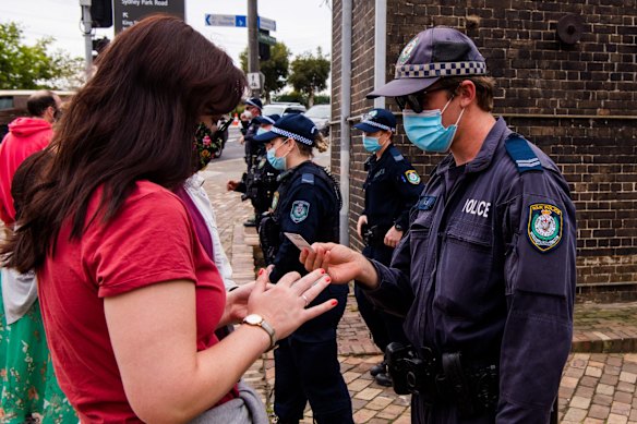 Police checking IDs at the entrance to Sydney Park, as a heavy police presence patrol in anticipation of planned anti-lockdown protests today.