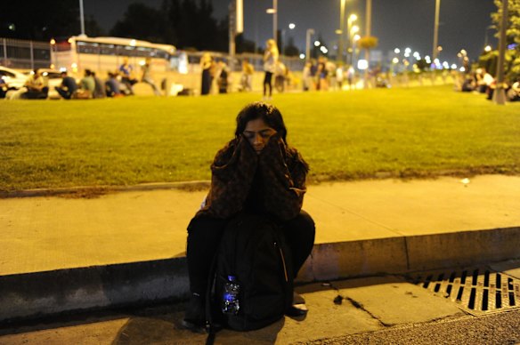 A passenger sits dejectedly outside the Turkey's largest airport, Istanbul Ataturk after the suicide bomb attacks.