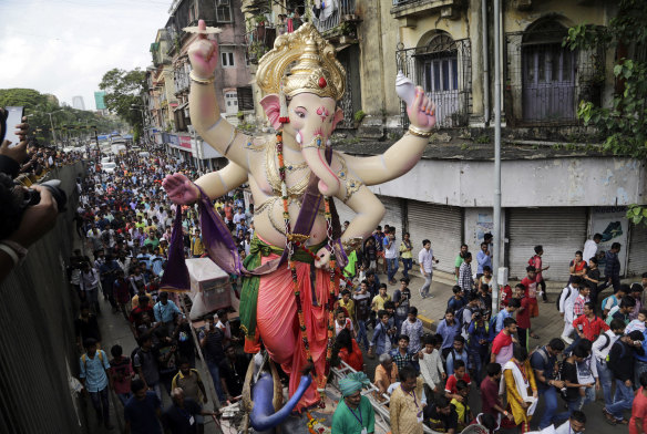 A giant statue of the god Ganesha  is paraded through the streets of Mumbai.