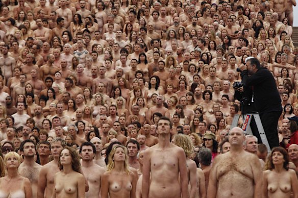  Spencer Tunick photographs naked volunteers as they pose for him in front of the Sydney Opera House.