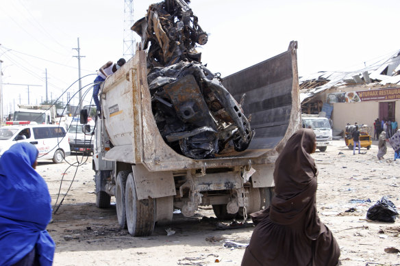 A truck carries wreckage of a car used in a bomb. 