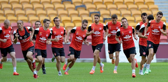 Players run to warm up during a Western Sydney Wanderers A-League training session at Suncorp Stadium.