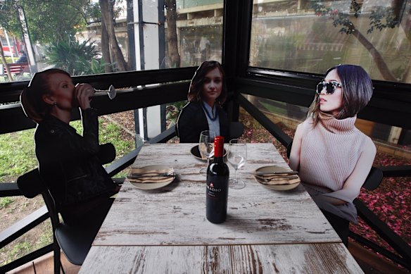 Co-owners of Five Dock Dining, Charles Garzaniti and Frank Angilletta have chosen a novel approach to the partial reopening their restaurant in Five Dock as the lifting of restrictions allows them to cater for 10 people. The pair sourced royalty free stock library images of ordinary people from the internet, printed them out life sized and positioned them around to create a feel that diners where not alone and feel comfortable in the sparse environment. 