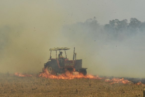 Spot fires threaten to overwhelm RFS volunteer firefighters at the Hillville fire on NSW Mid north coast. Constant swirling winds and dry fuel has allowed the fire to spot often threatening and destroying homes.