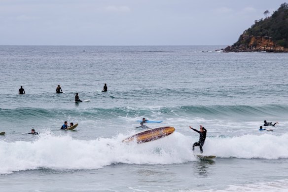 Surfing at Manly Beach, an activity allowed, after a COVID-19 outbreak in Avalon sent the Northern Beaches into lockdown.