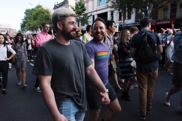 Crowds march down Oxford St, Darlinghurst this evening to celebrate the majority yes vote of the results of the postal vote.