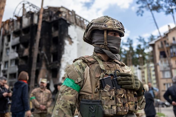 A Ukrainian army soldier stands guard at a war damaged residential complex after UN Secretary-General Antonio Guterres visited Irpin. The secretary-general visited several towns around Kyiv heavily damaged by Russian forces in their failed bid to take Kyiv.