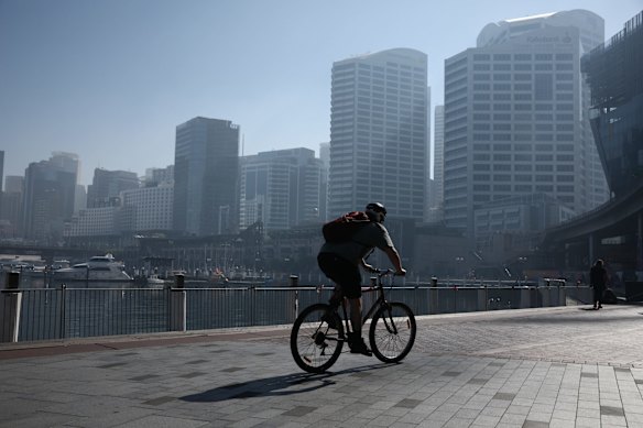 A cyclist braves the smoke in Sydney's Darling Harbour this morning.