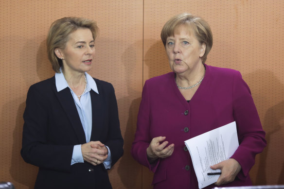 German Chancellor Angela Merkel, right, talks to Defense Minister Ursula von der Leyen.