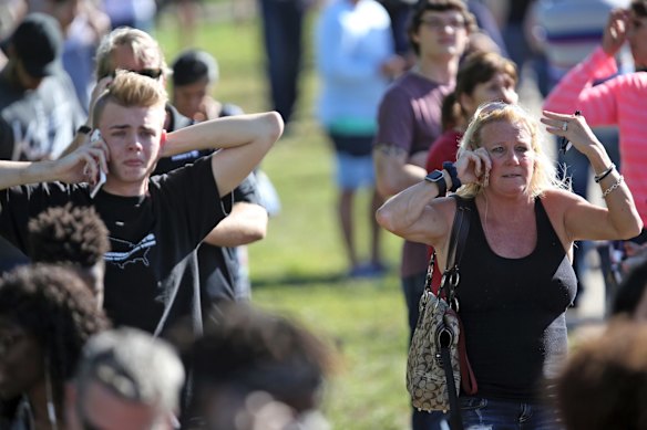 Waiting for word from students anxious family members gather at Coral Springs Drive and the Sawgrass Expressway, just south of the campus ,following a shooting at Marjory Stoneman Douglas High School in Parkland, Florida.