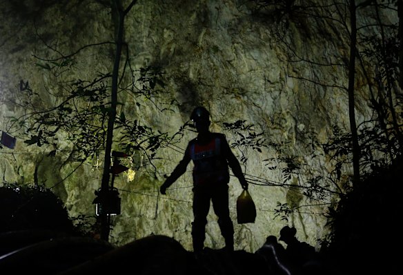 Rescuers make their way down at the entrance to a cave complex where 12 boys and their soccer coach went missing, in Mae Sai, Chiang Rai province, in northern Thailand.