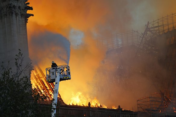 A fire fighter attempts to douse the flames.