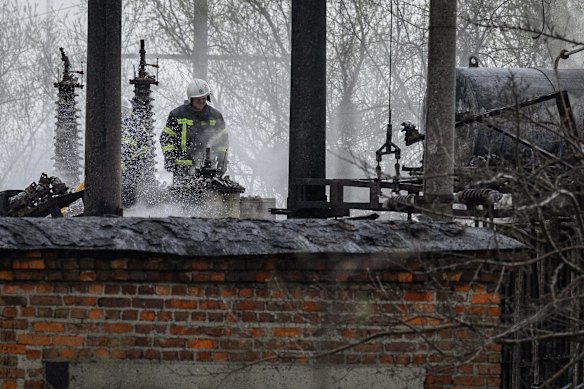 A firefighter surveys the damage at an electrical substation supplying power to nearby rail lines, which officials said were the target of a Russian missile attack near Lviv. The head of Ukrainian Railways said in a social media post today that five rail facilities had been attacked by Russia this morning in Krasne, near Lviv.