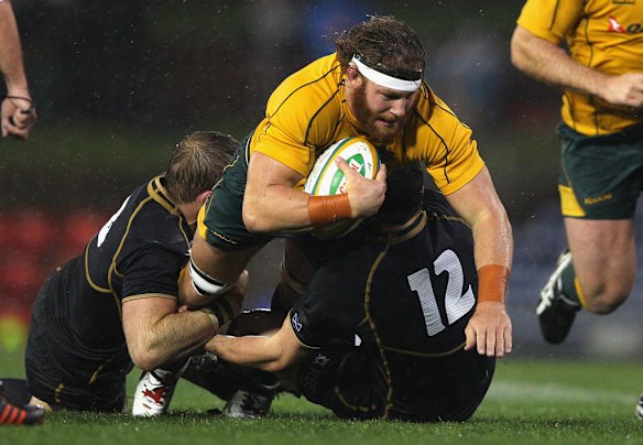 Scott Higginbotham of Australia is tackled during the International Test match between the Australian Wallabies and Scotland at Hunter Stadium on June 5, 2012 in Newcastle, Australia.