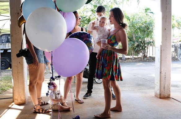 Bethan McElwee holds Aviana as she inspects her birthday decorations. 