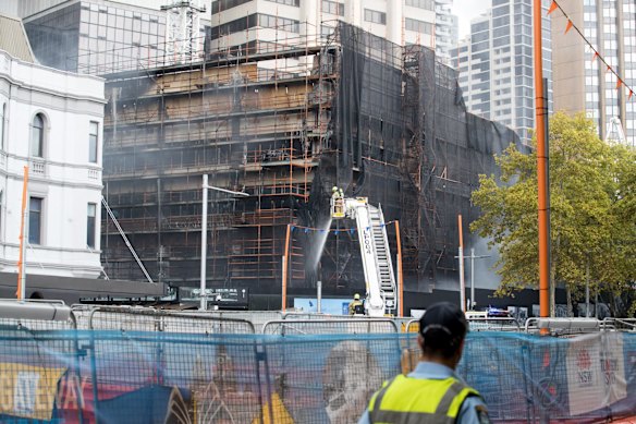 Firefighters extinguish the fire in Circular Quay.