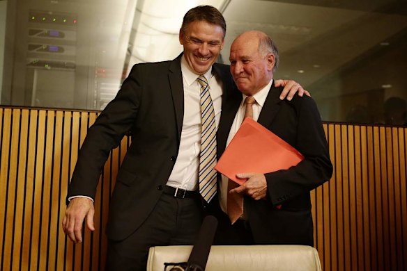 Independent MP Rob Oakeshott and Independent MP Tony Windsor embrace at Parliament House.