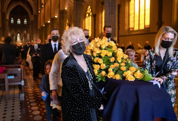 Patti Newton and daughter Lauren carry Bert Newton's coffin out of St Patricks Cathedral, following his state funeral service.
