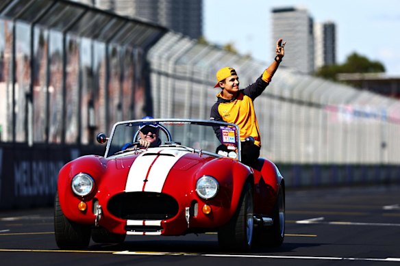 Lando Norris of Great Britain and McLaren waves to the crowd on the drivers parade.