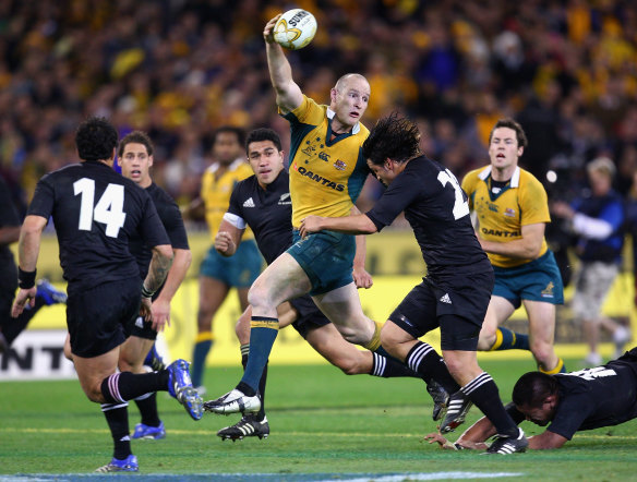 Stirling Mortlock offloads for a Wallabies try in 2007 at the MCG.