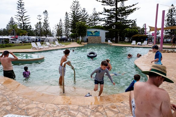 Swimmers at the Toowoon Bay Holiday Park, on the Central Coast. It is busier than usual due to travel restrictions, causing people to holiday closer to home.