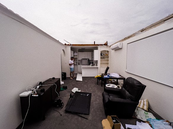 Dee Why resident Nathan Lavers in his unit on Pacific Parade, Dee Why, whose roof was ripped off during the “microburst” , a severe storm downdraft often with winds exceeding 100kph. 