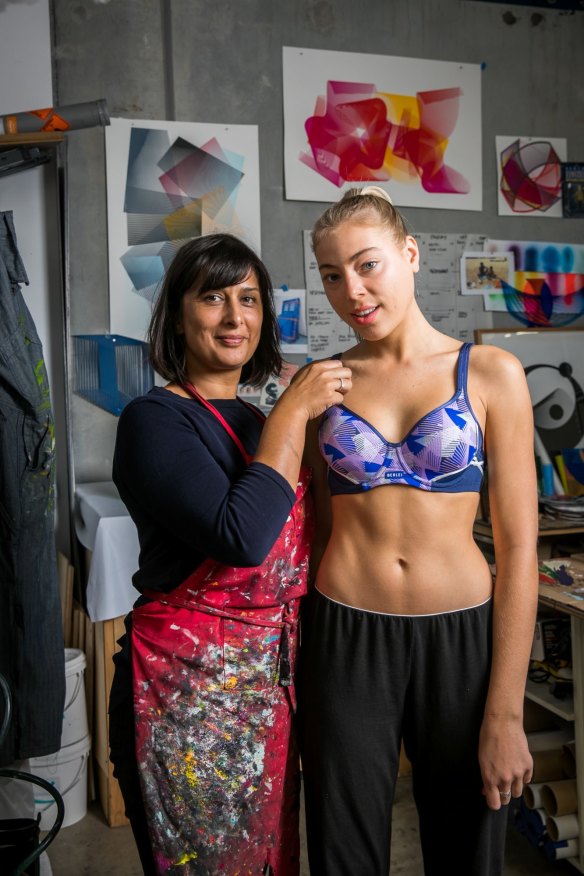 Screen printer Kate Banazi and a model show the new Berlei sports bra designs.